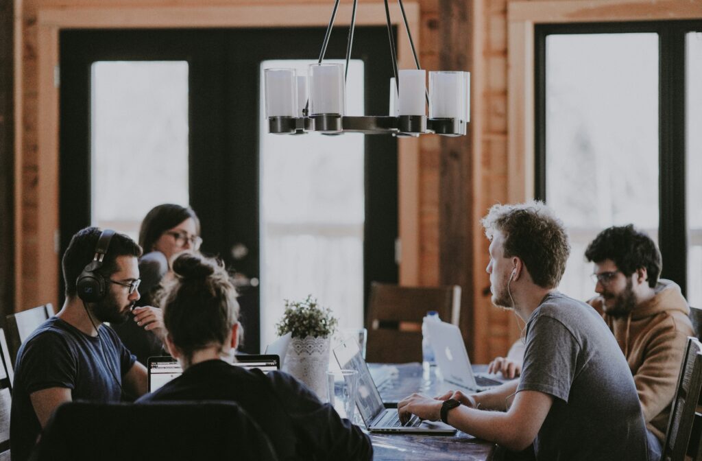 Group around a table talking about how to enhance your PMO through redefined accountability.