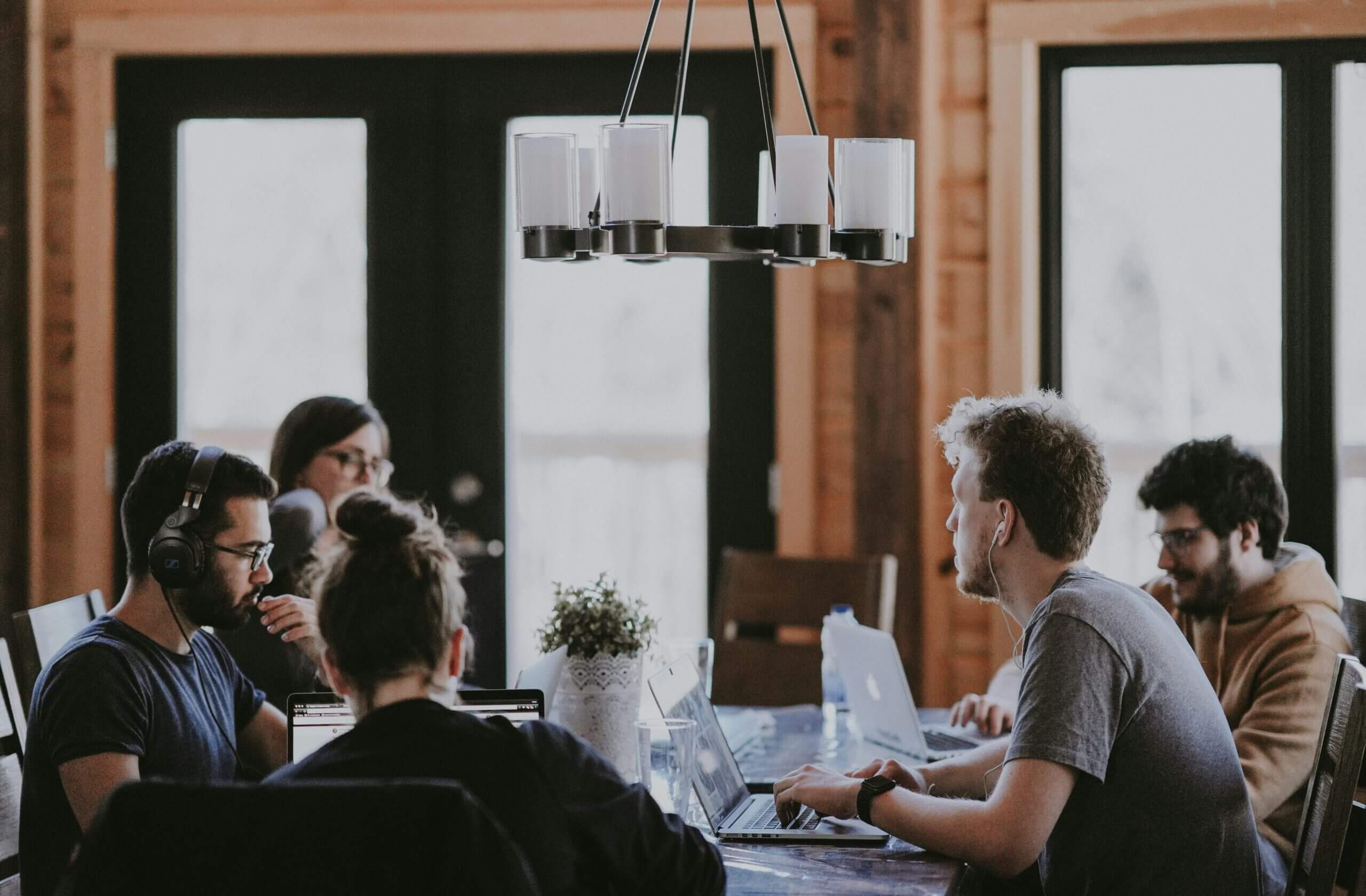 Group around a table talking about how to enhance your PMO through redefined accountability.