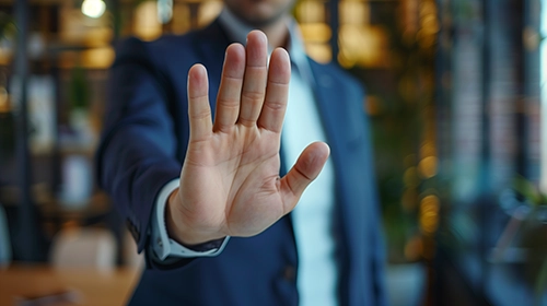 Person's hand is up to signal resisting user stories.